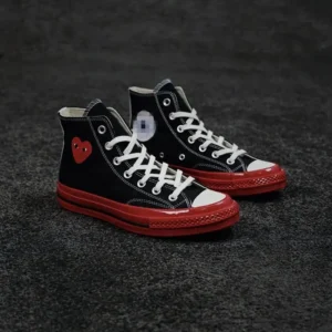 CDG's high-top black and red shoes with a heart design