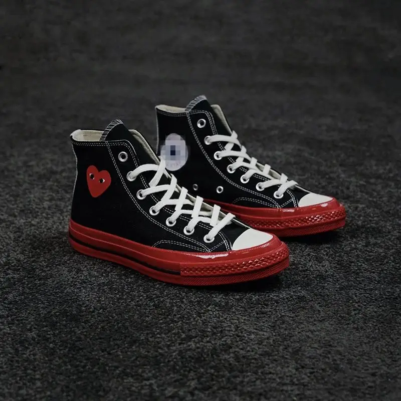 CDG's high-top black and red shoes with a heart design
