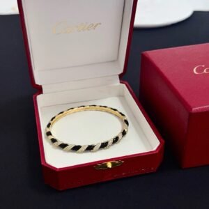 Cartier's classic black and gold diamond - set bracelet.
