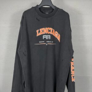 The Balenciaga ripped black hoodie with a trendy style.